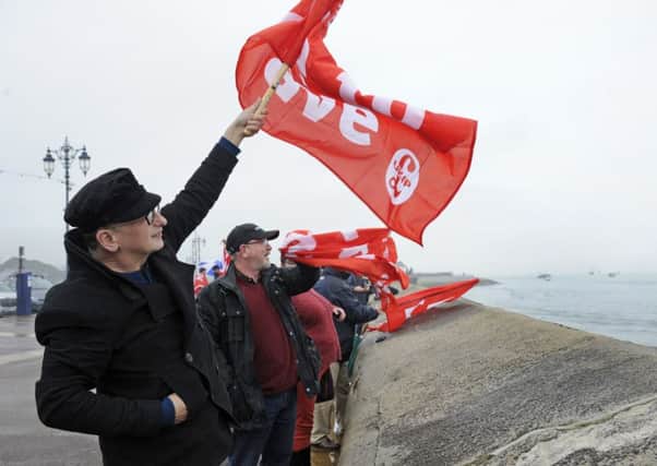 Supporters cheer on fishermen staging a waterborne protest against the EU outside Portsmouth Harbour
