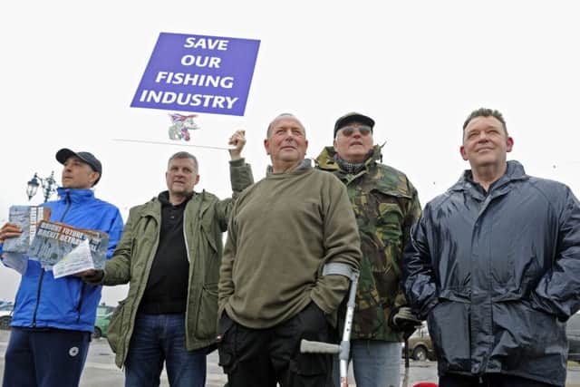 Supporters cheer on fishermen staging a waterborne protest against the EU outside Portsmouth Harbour