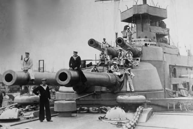 A job long gone  since the passing of the big-gun ships, polishing the brass work and the tampions of the guns. Picture: Robert James Collection