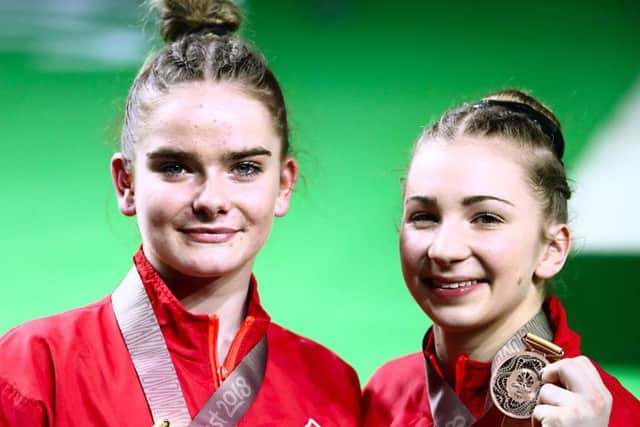 Kelly Simm, right, celebrates his women's beam bronze medal with Alice Kinsella, who won gold. Picture: Danny Lawson/PA Wire/PA Images