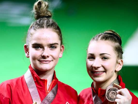 Kelly Simm, right, celebrates his women's beam bronze medal with Alice Kinsella, who won gold. Picture: Danny Lawson/PA Wire/PA Images
