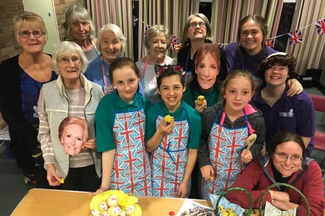 CAP:  Girls from the 2nd Hayling Girls Brigade group and the St Andrews  Ladies group enjoy their baking contest with the Rev Jenny Gaffin (bottom right)