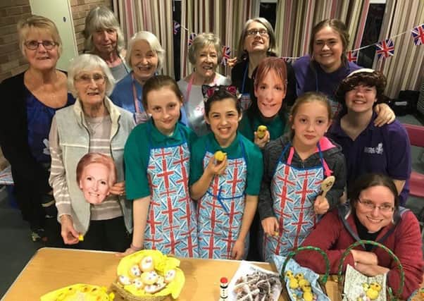 CAP:  Girls from the 2nd Hayling Girls Brigade group and the St Andrews  Ladies group enjoy their baking contest with the Rev Jenny Gaffin (bottom right)
