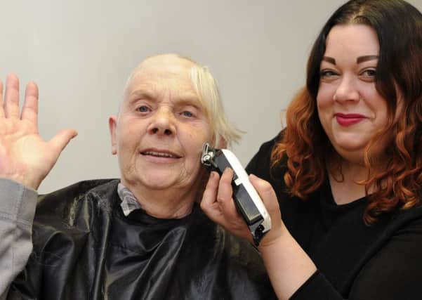 Hairdresser Michelle Winterbottom shaves Janet Monroe's hair for charity.
 Picture by Ian Hargreaves