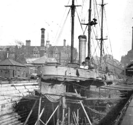 Discovery in Camber Dock in 1925 for reconstruction. The dry dock was later used for unloading coal for the new power station. 
Picture: Stephen Payne Collection.