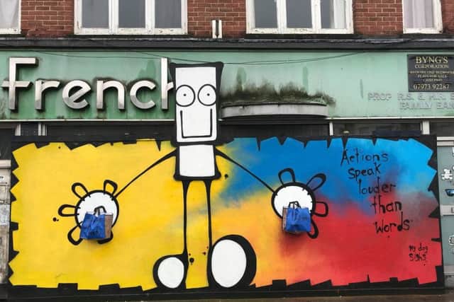 The My Dog Sighs mural with shopping bags attached