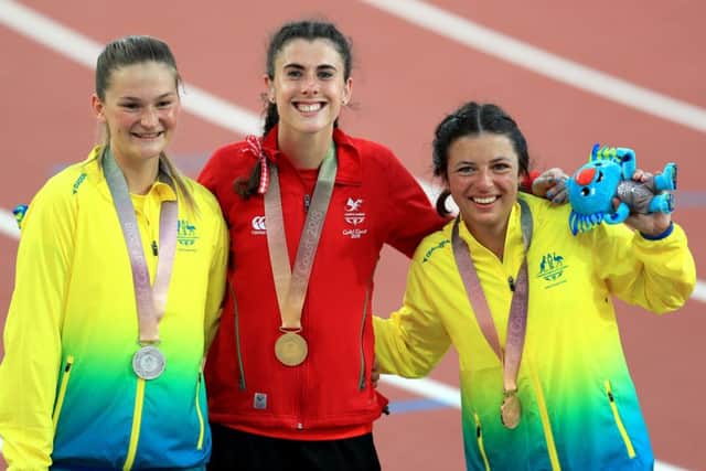 Wales' Olivia Breen, centre, with her gold medal, Australia's Erin Cleaver, left, with her silver medal and Australia's Taylor Doyle, right, with her bronze medal in the women's T38 long jump final at the Carrara Stadium during the Commonwealth Games in Australia. Picture: Mike Egerton/PA