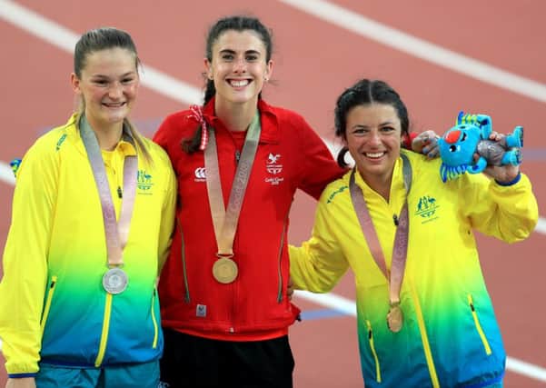 Wales' Olivia Breen, centre, with her gold medal, Australia's Erin Cleaver, left, with her silver medal and Australia's Taylor Doyle, right, with her bronze medal in the women's T38 long jump final at the Carrara Stadium during the Commonwealth Games in Australia. Picture: Mike Egerton/PA