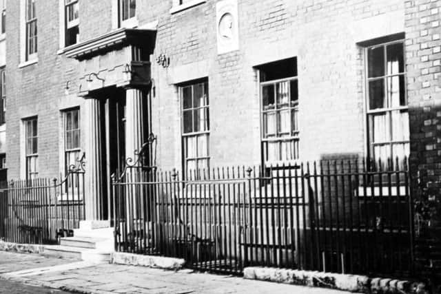 Standing in Highbury Street, Old Portsmouth here we see the home of Admiral Lord Howe with a relief built into the wall.