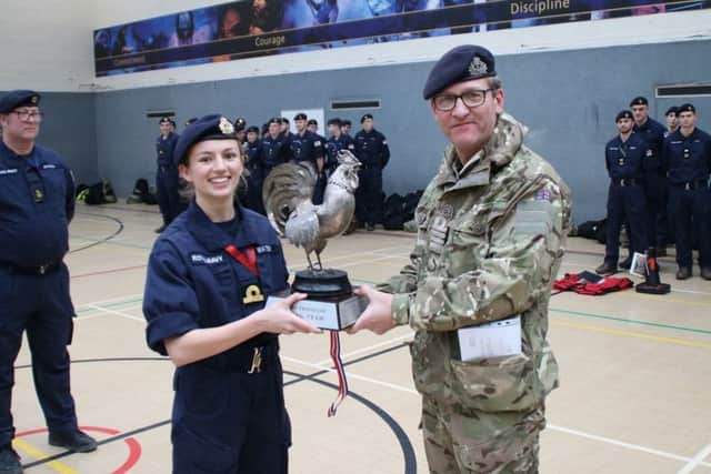 Captain Rob Vitali presents the Cockerel Trophy to Sub Lieutenant Watson