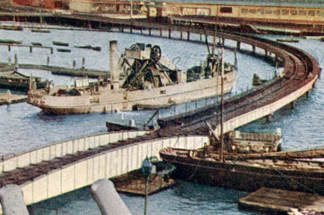 The railway viaduct hit by HMS Crocodile. The Crocodile hit the viaduct on the curve, parallel to the bows of the grey coloured vessel.