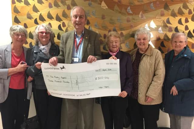 Castle View Portchester Womens Institute members present a Â£300 cheque to Mick Lyons