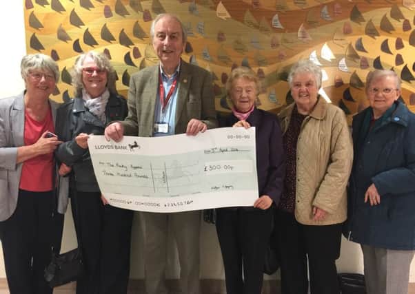 Castle View Portchester Womens Institute members present a Â£300 cheque to Mick Lyons