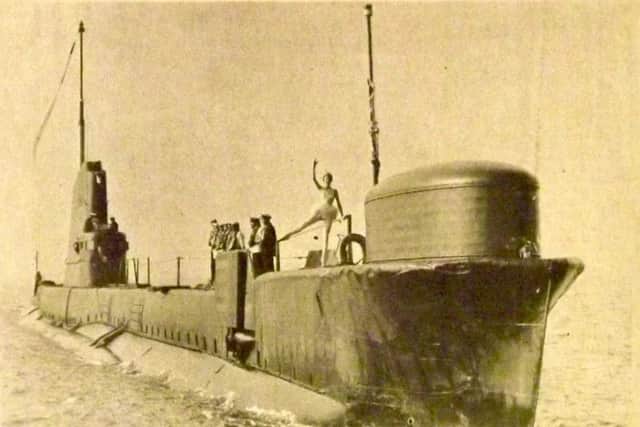 HMS Tiptoe approaching Portsmouth Harbour for the final time with Judy Wright dancing on her deck.