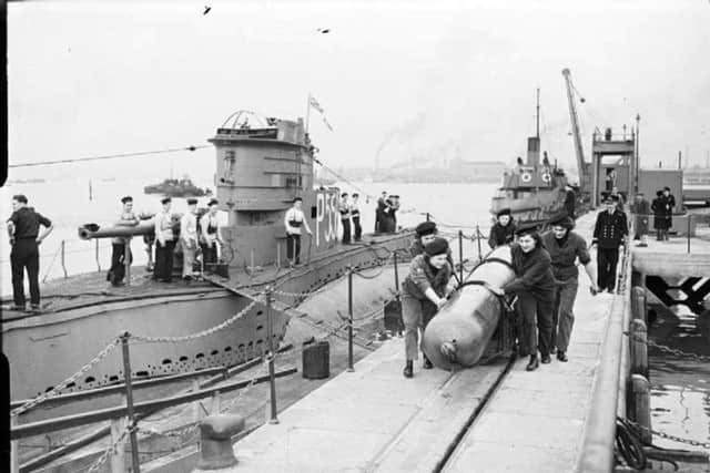 HM Submarine  P556  is berthed at (as it was then ) Fort Blockhouse. Wrens are pushing the torpedo. (Mike Nolan coll.)