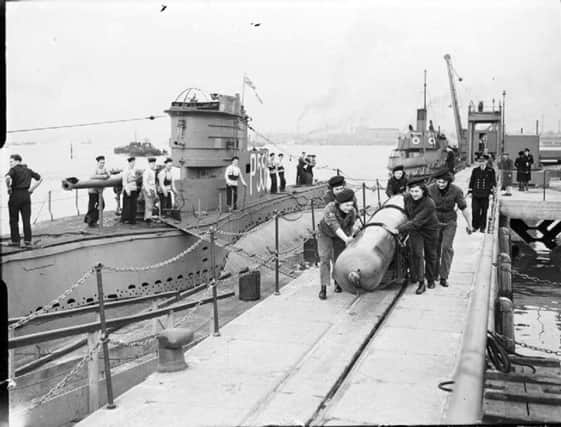 HM Submarine  P556  is berthed at (as it was then ) Fort Blockhouse. Wrens are pushing the torpedo. (Mike Nolan coll.)
