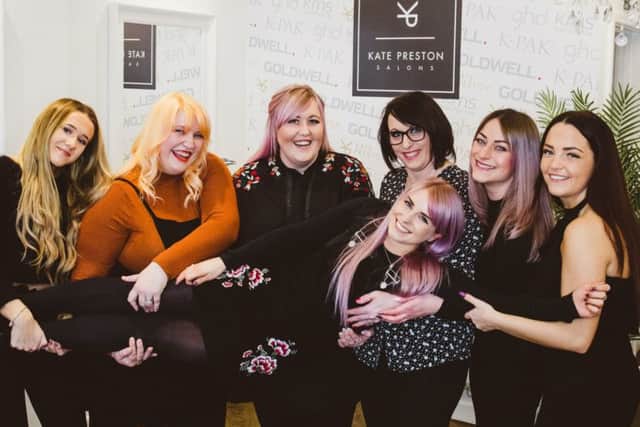 Staff at the newly opened Kate Preston Salon in Gosport give Liberty Rock a celebratory lift.