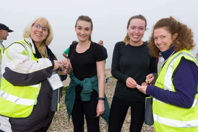 Ali Watson  and Katy Bradley scan finishing tokens for first time parkrunners Rebecca Howell and Jess Gwynn