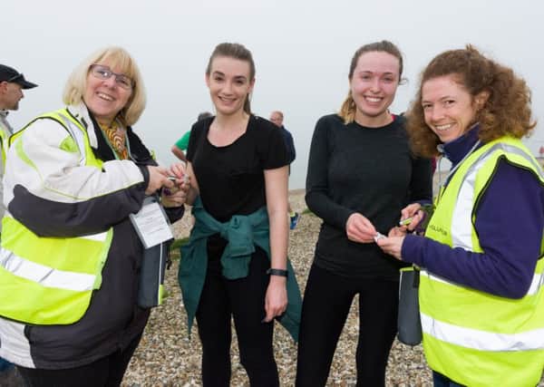 Ali Watson  and Katy Bradley scan finishing tokens for first time parkrunners Rebecca Howell and Jess Gwynn