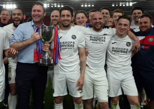 Lee Bradbury joins his Hawks team to celebrate his side's Hampshire Senior Cup victory at St Mary's Picture: Chris Moorhouse