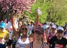 Kelle Russell with arms raised