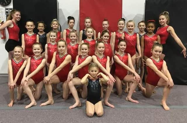 A group of young gymnasts from The Academy of Gym