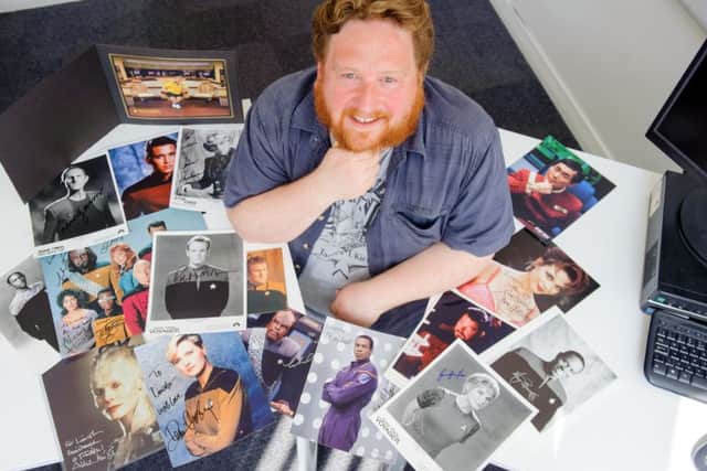 Dr Lincoln Geraghty pictured with his collection of autographs from characters from Star Trek