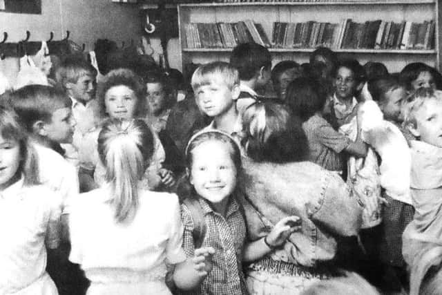 jpns 260518 retro may 2018School - Leaving for home, the crush of pupils in the small lobby of one of the temporary classrooms