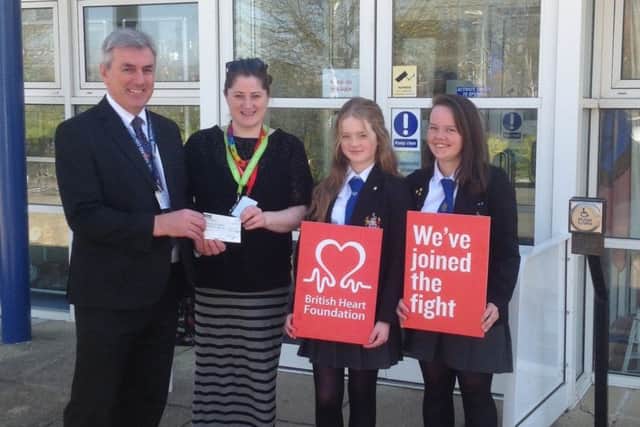 From left, headteacher Colin Rainford, BHF fundraising manager Gemma Hodgkiss and pupils Amelie Combe and Rose Williamson