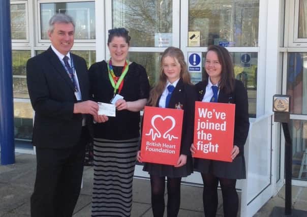 From left, headteacher Colin Rainford, BHF fundraising manager Gemma Hodgkiss and pupils Amelie Combe and Rose Williamson