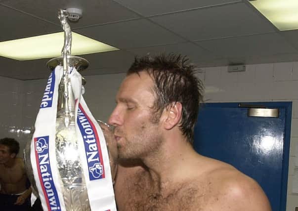 Paul Merson with the Division One title