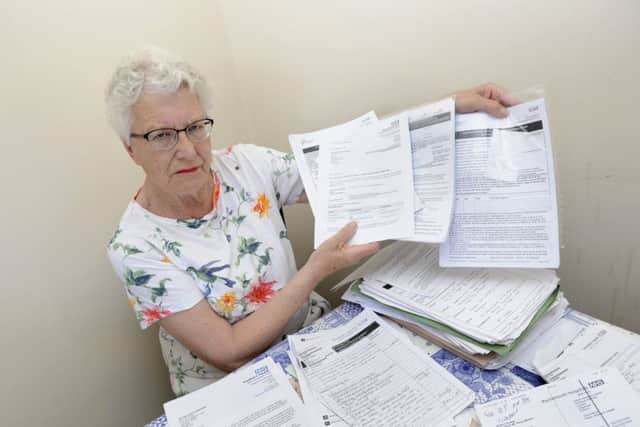 Jill Smart from Gosport with the mountain of paper work she has had to deal with for her husband Leslie who has been in hospital for 19 months
Picture: Ian Hargreaves (180459-2)