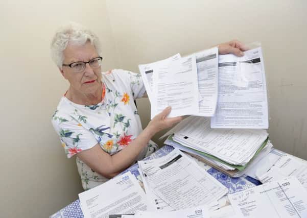 Jill Smart from Gosport with the mountain of paper work she has had to deal with for her husband Leslie who has been in hospital for 19 months     
Picture: Ian Hargreaves (180459-2)