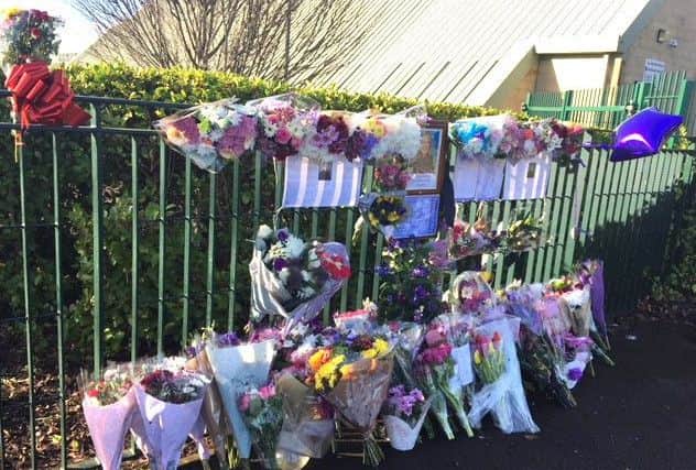 Floral tributes at The Henry Cort Community College to teacher Helen Lloyd