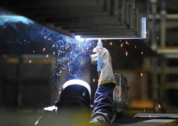A welder at work during construction of the new aircraft carrier HMS Queen Elizabeth