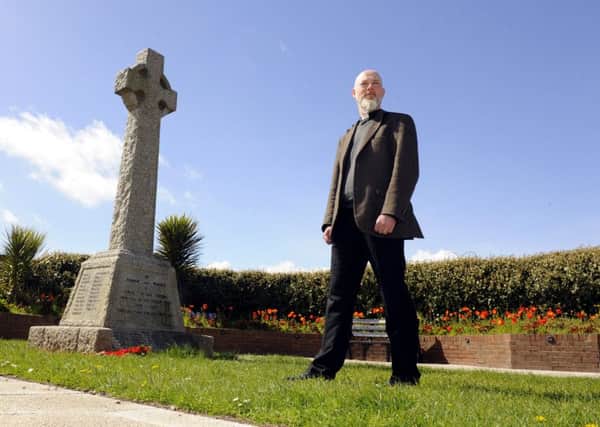 The Rev Dr Paul Chamberlain, the Vicar of St Faith's Church in Lee-on-the-Solent with the town's war memorial. 


Picture: Malcolm Wells (180426-6030)