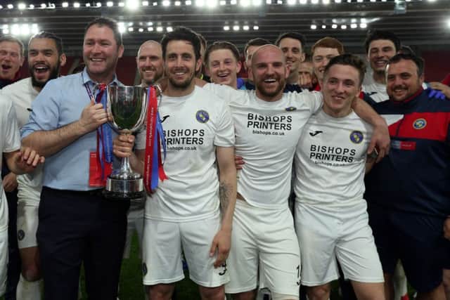 Brian Stock and manager Lee Bradbury hold the trophy. Picture: Chris Moorhouse