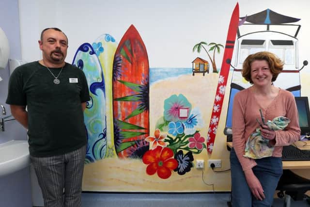 Artist Sally Goodden and lead nurse Mark Friend in the adolescent treatment room at St Mary's Hospital with the 'surf scene' mural painted by artist Karen Burling.
Picture by Chris Moorhouse