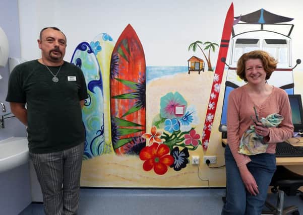 Artist Sally Goodden and lead nurse Mark Friend in the adolescent treatment room at St Mary's Hospital with the 'surf scene' mural painted by artist Karen Burling. 
Picture by Chris Moorhouse