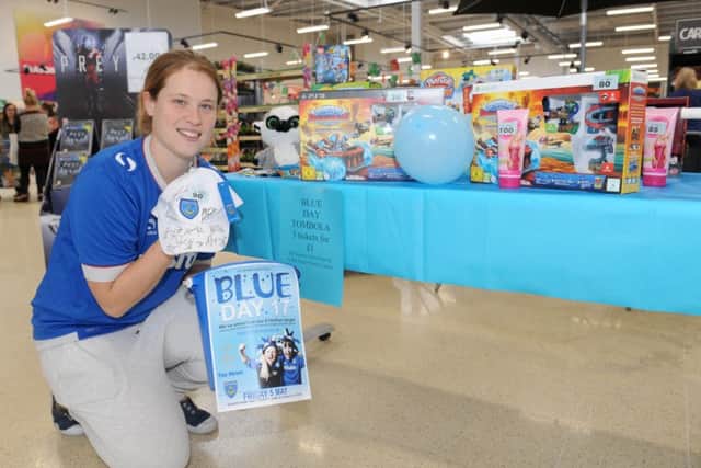 Gemma Morrison, community champion at Tesco Extra in Fratton, with some of the tombola Blue Day prizes last year
Picture: Sarah Standing (170585-7045)