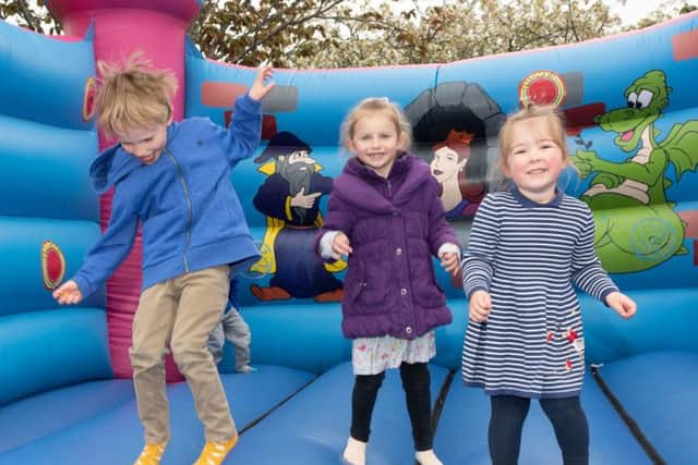 Enjoying themselves on the bouncy council at the Hi-5 Fun Day. Picture: Keith Woodland