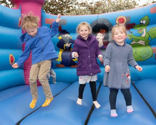 Enjoying themselves on the bouncy council at the Hi-5 Fun Day. Picture: Keith Woodland