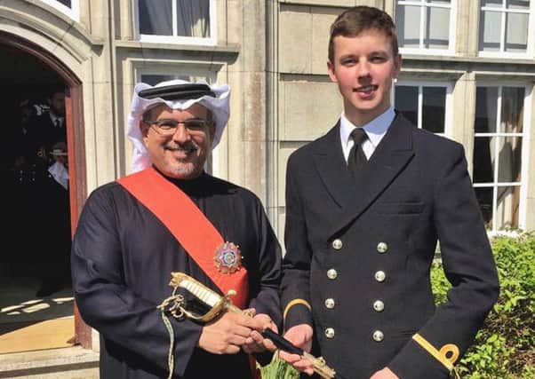 Prince Salman bin Hamad Al Khalifa, crown prince of Bahrain, presenting the Queen's Sword to Sub Lieutenant Tom Hillier, 22, of Gosport, who was named the top officer in training across all the navy's intake in 2017