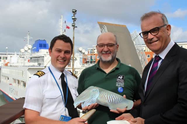 Wightlink chief officer Toby Hughes, Tim Ferrero from Hampshire and Isle of Wight Wildlife Trust and Wightlink chief executive Keith Greenfield with a cuttlefish model and cuttlebones