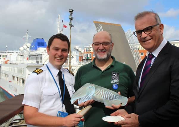 Wightlink chief officer Toby Hughes, Tim Ferrero from Hampshire and Isle of Wight Wildlife Trust and Wightlink chief executive Keith Greenfield with a cuttlefish model and cuttlebones
