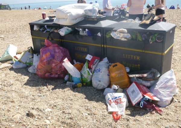 Bins surrounded by stacks of rubbish near the West Beach car park on Hayling Island