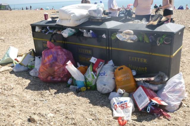 Bins surrounded by stacks of rubbish near the West Beach car park on Hayling Island