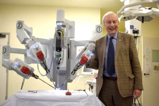 Mick Lyons, co-ordinator of the Rocky Appeal, with the Da Vinci robot. Picture: Martyn Roberts  clinical photographer