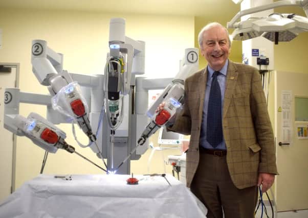 Mick Lyons, co-ordinator of the Rocky Appeal, with the Da Vinci robot. Picture: Martyn Roberts  clinical photographer