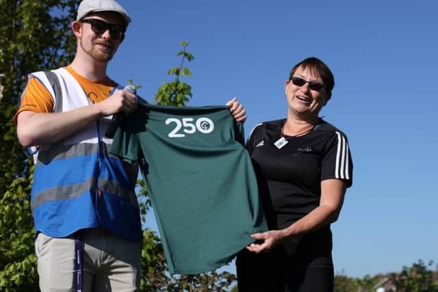 Fareham parkrun run director Brendan Tuttiett presents a shirt to Margaret McGilp who is in the 250 club. Picture: Chris Moorhouse